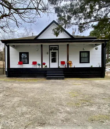 a front view of a house with two trees