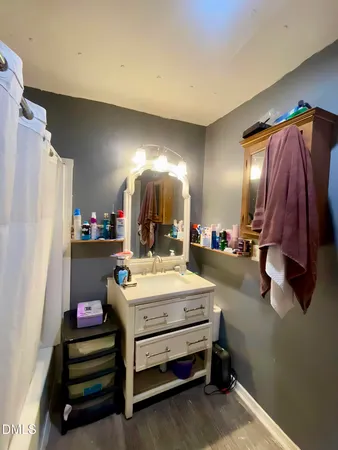 a bathroom with a toilet and a shower curtain