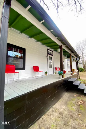 a backyard of a house with yard and outdoor seating