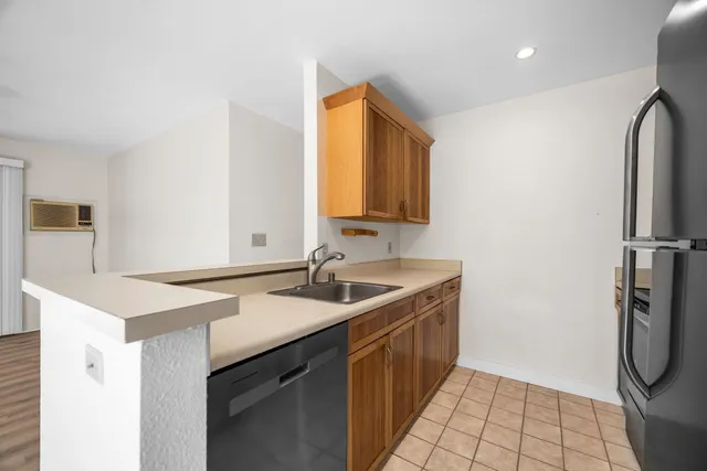 a kitchen with stainless steel appliances granite countertop a refrigerator and a stove