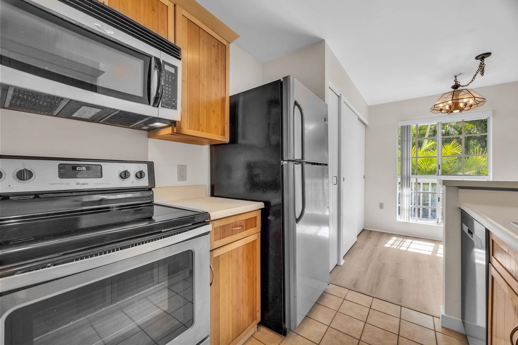 160 Keonekai Road, Unit 18202 Kihei, HI 96753 - Photo 17 of 25 a kitchen with stainless steel appliances granite countertop a refrigerator and a stove
