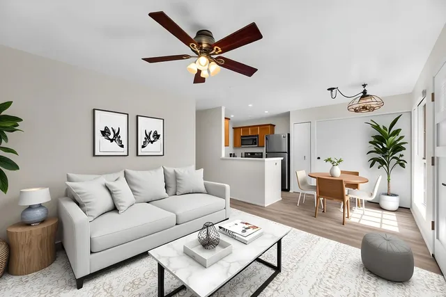 a living room with furniture and a wooden floor