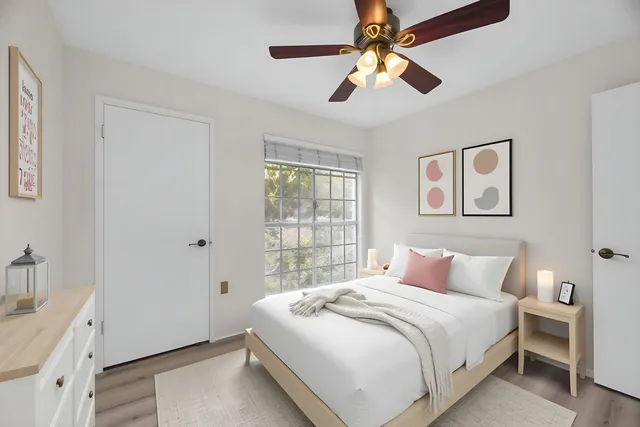 a bedroom with a large bed and a chandelier