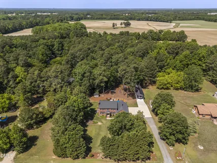 an aerial view of a houses with outdoor space and river