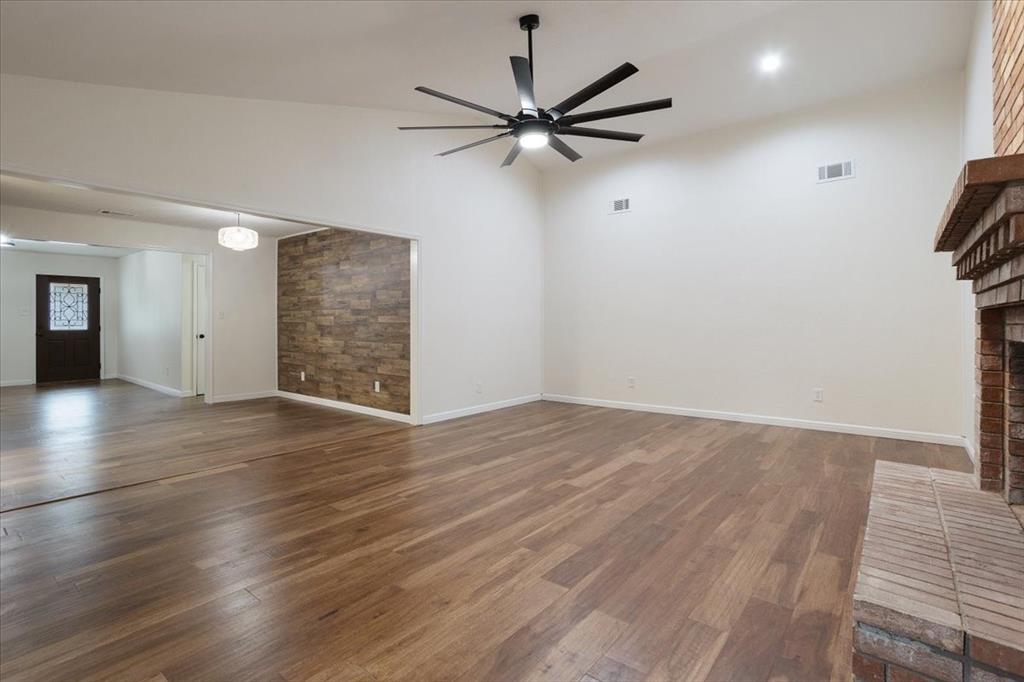 100 East Cunningham Street Bonham, TX 75418 - Photo 14 of 35 wooden floor in an empty room with a window