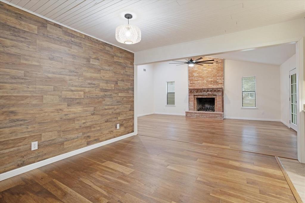 100 East Cunningham Street Bonham, TX 75418 - Photo 16 of 35 a view of empty room with wooden floor and fireplace