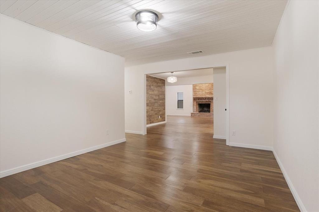 100 East Cunningham Street Bonham, TX 75418 - Photo 22 of 35 wooden floor in an empty room with a window