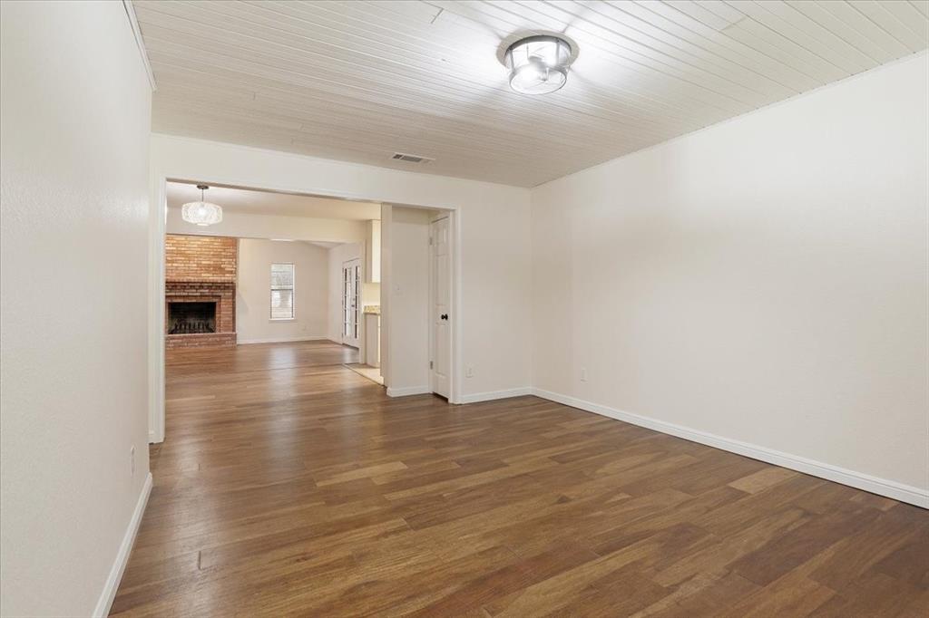 100 East Cunningham Street Bonham, TX 75418 - Photo 23 of 35 an empty room with wooden floor and windows