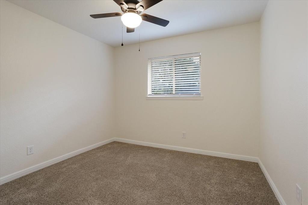 100 East Cunningham Street Bonham, TX 75418 - Photo 30 of 35 an empty room with a window and a fan