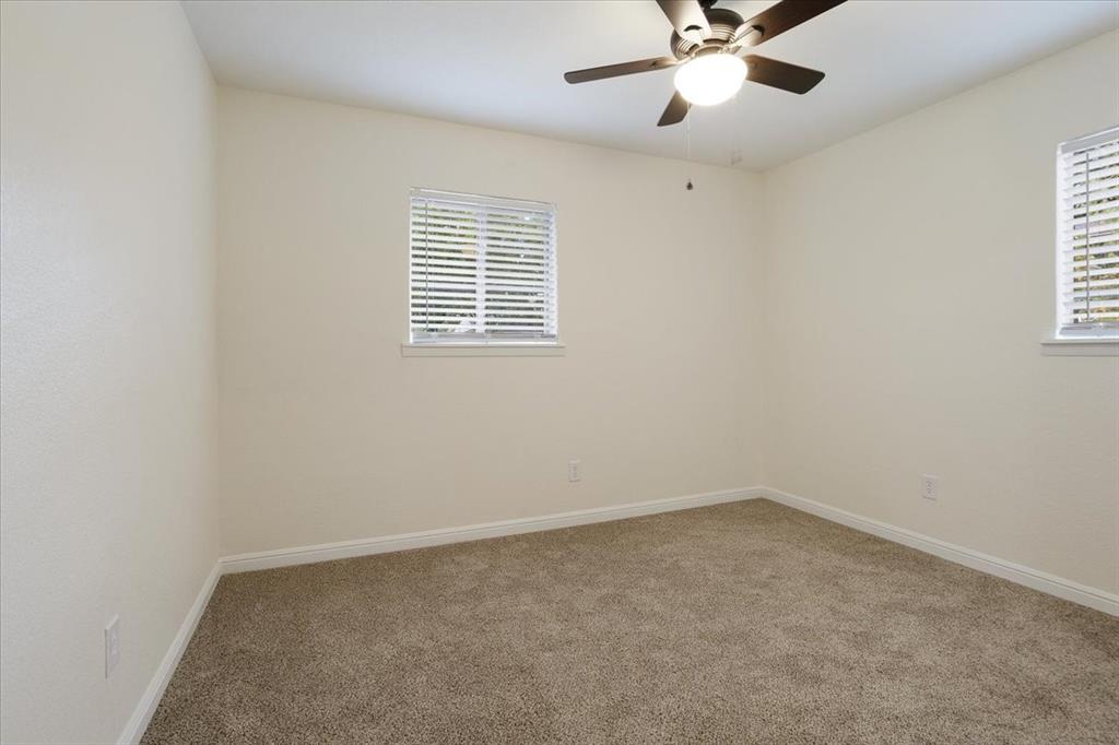 100 East Cunningham Street Bonham, TX 75418 - Photo 32 of 35 an empty room with a window and a fan