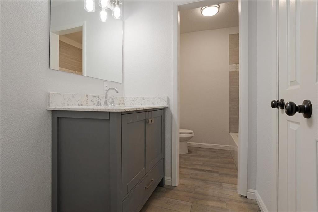 100 East Cunningham Street Bonham, TX 75418 - Photo 34 of 35 a bathroom with a sink and mirror