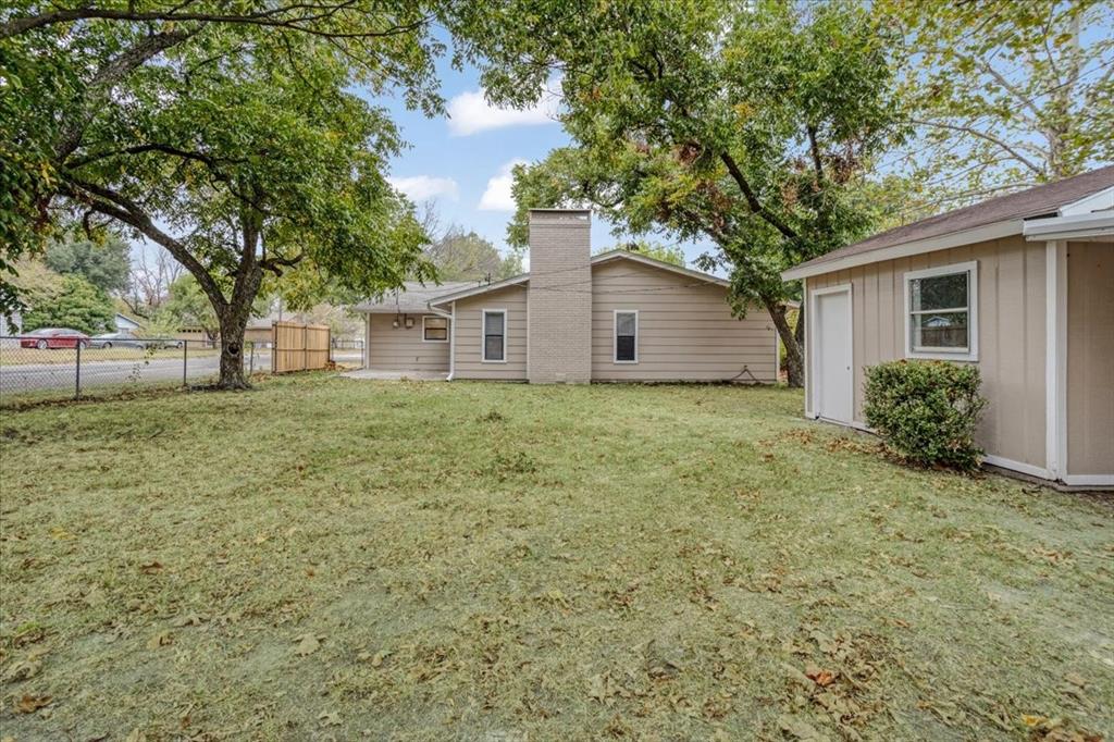 100 East Cunningham Street Bonham, TX 75418 - Photo 7 of 35 a white house that has a tree in front of it