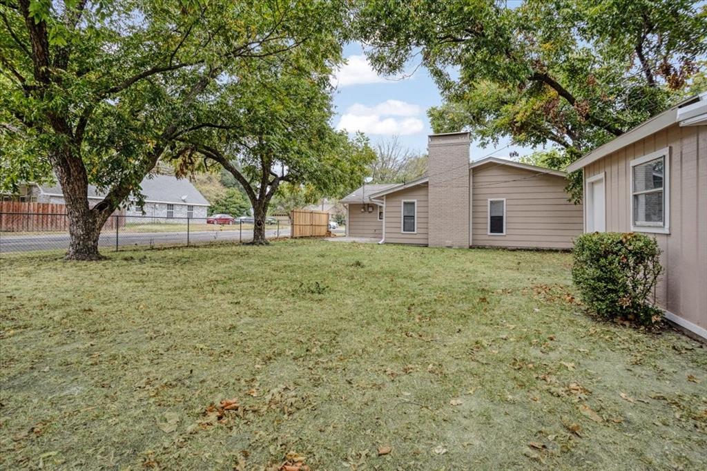 100 East Cunningham Street Bonham, TX 75418 - Photo 8 of 35 a white house that has a tree in front of it