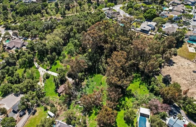 an aerial view of a houses with a yard