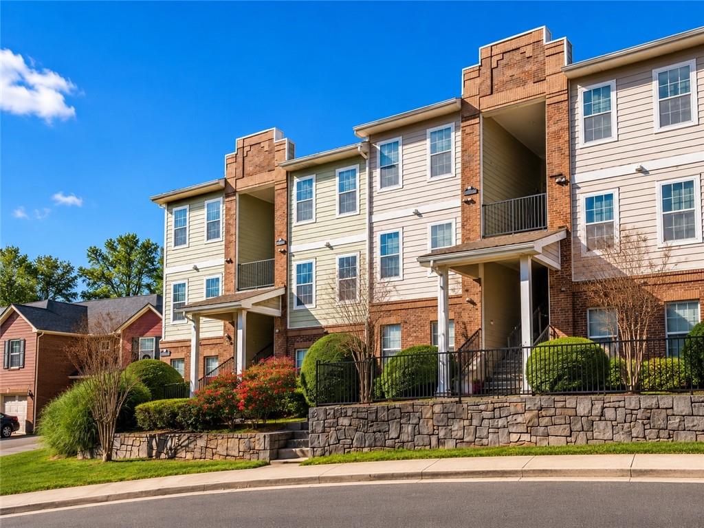 1752 Pryor Road Southwest, Unit 111 Atlanta, GA 30315 - Photo 20 of 21 a view of a building with a yard and plants
