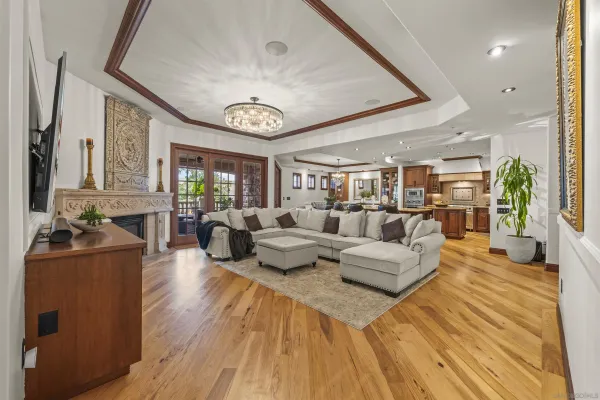 a living room with furniture and a chandelier
