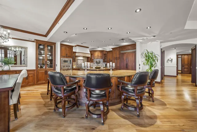 a kitchen with stainless steel appliances granite countertop wooden cabinets and sink