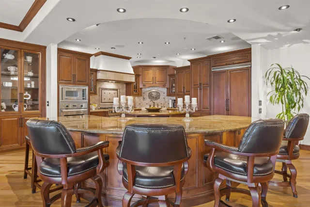 a kitchen with stainless steel appliances granite countertop a stove and a refrigerator