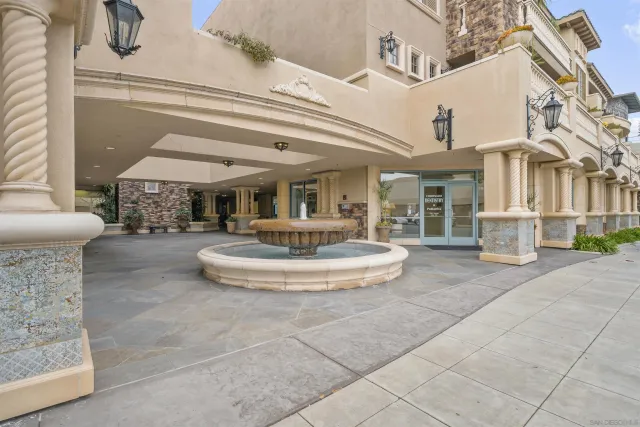 a view of a white building with swimming pool in front of it