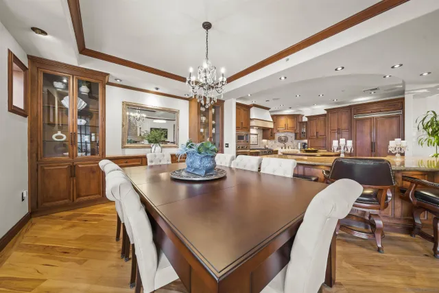 a view of a hallway with wooden floor and a bathroom