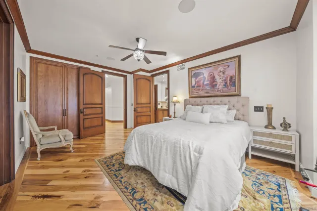 a spacious bedroom with a bed and a large window