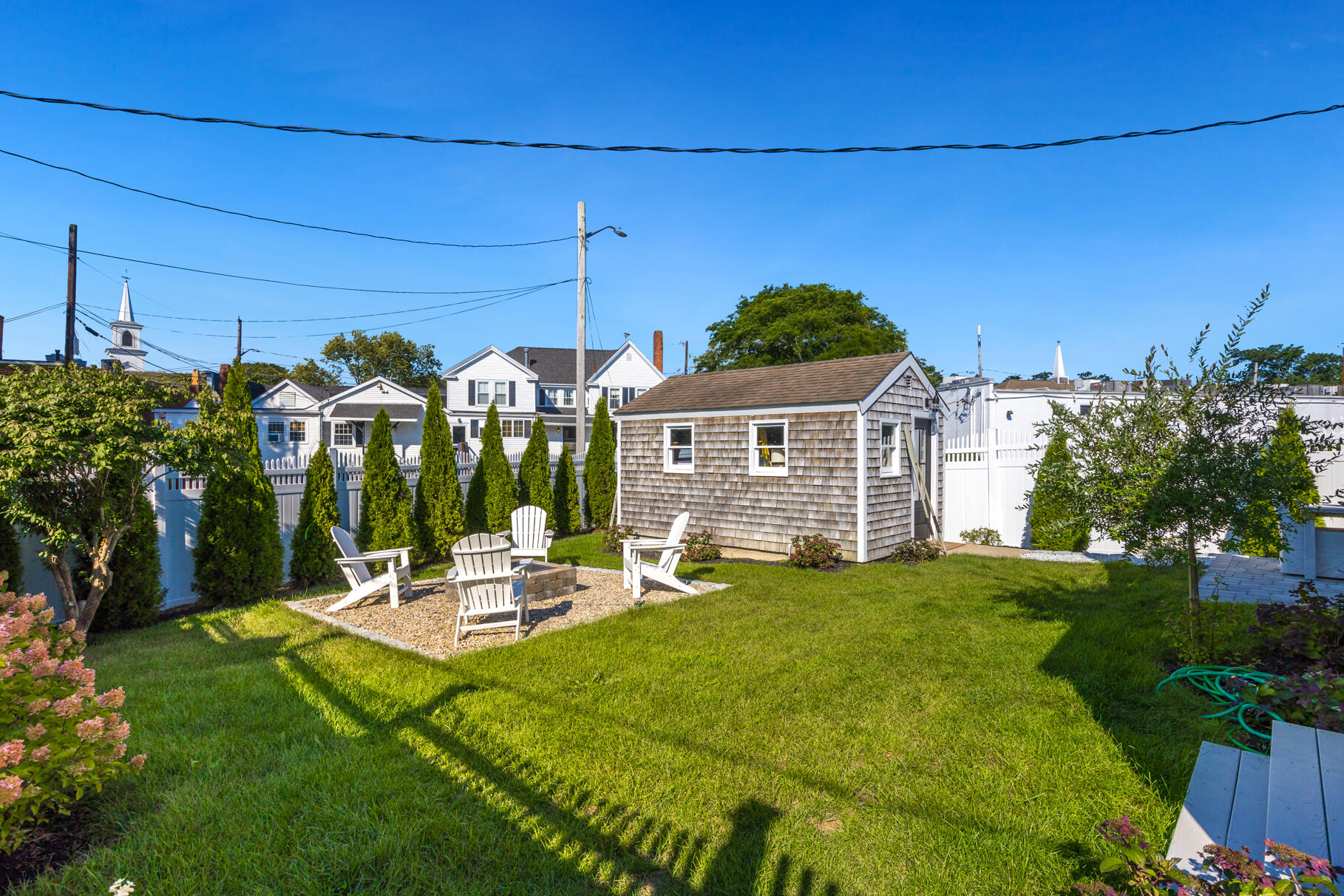 38 Sunset Lane Osterville, MA 02655 - Photo 19 of 39 a view of a patio with table and chairs potted plants and large tree