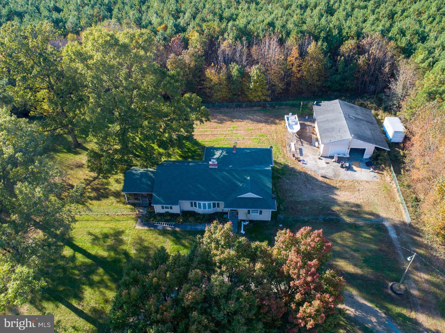 an aerial view of a house with yard swimming pool and outdoor seating