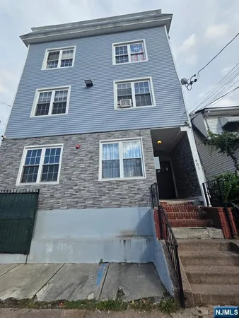 a front view of a house with stairs