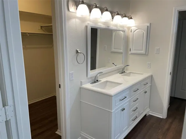 a bathroom with a double vanity sink and mirror