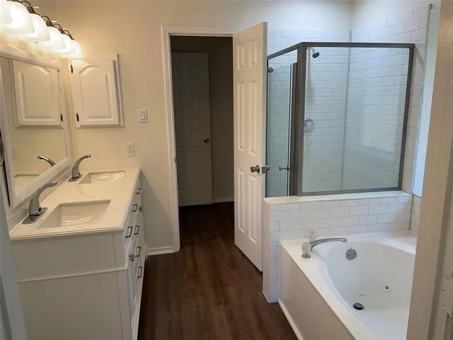 a bathroom with a sink a mirror and a bathtub