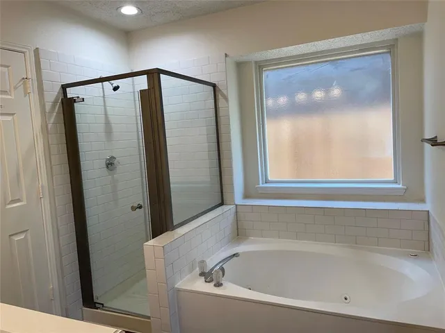 a bathroom with a bathtub and a shower