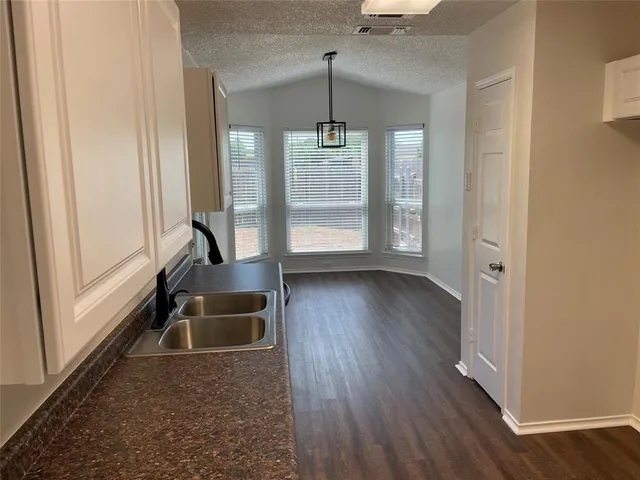 a view of a livingroom with wooden floor and white walls