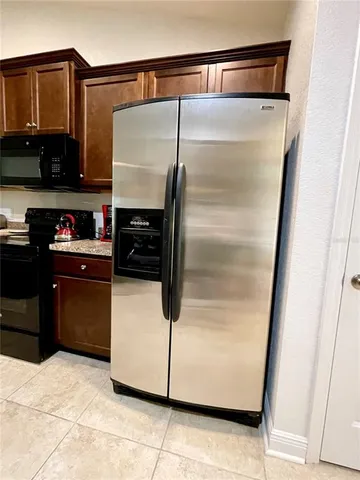 a kitchen with stainless steel appliances granite countertop a stove a sink dishwasher and a microwave
