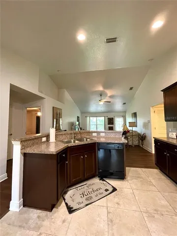 a kitchen with granite countertop a sink and a window
