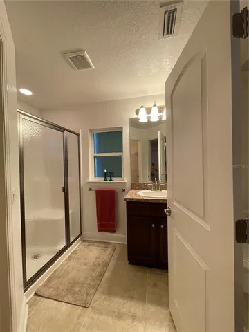 a bathroom with a tub sink and mirror
