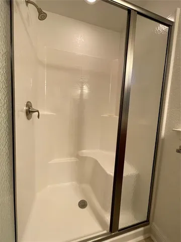 a bedroom with bed and a window