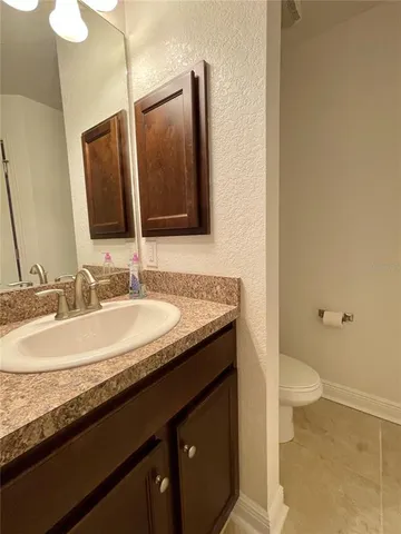 a bedroom with a bed and a television