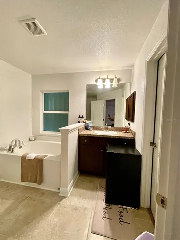 a bathroom with a shower a toilet and a tub