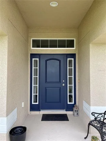 a living room with a chair and a large window