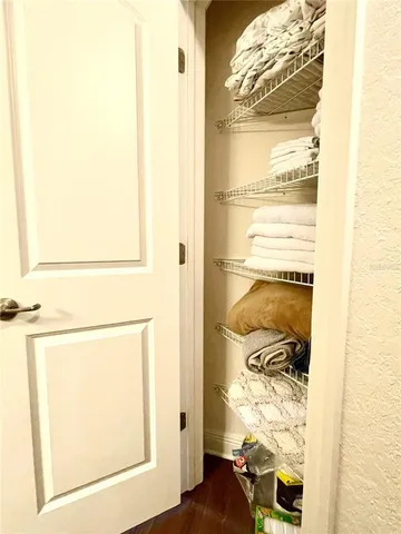 a bed sitting in a bedroom next to a lamp