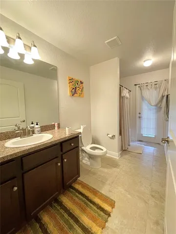 a front view of a house with a garden and plants