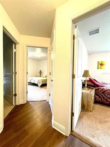 a front view of a house with a garden and trees