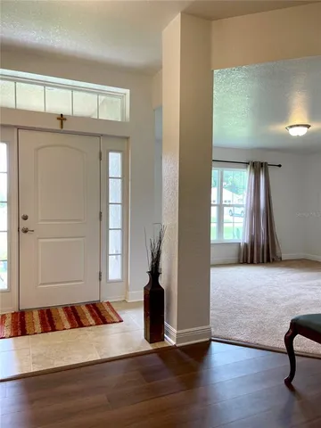 a living room with a couch and wooden floor