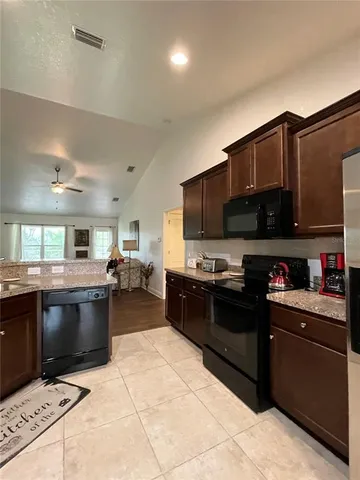 a kitchen with a refrigerator and a sink