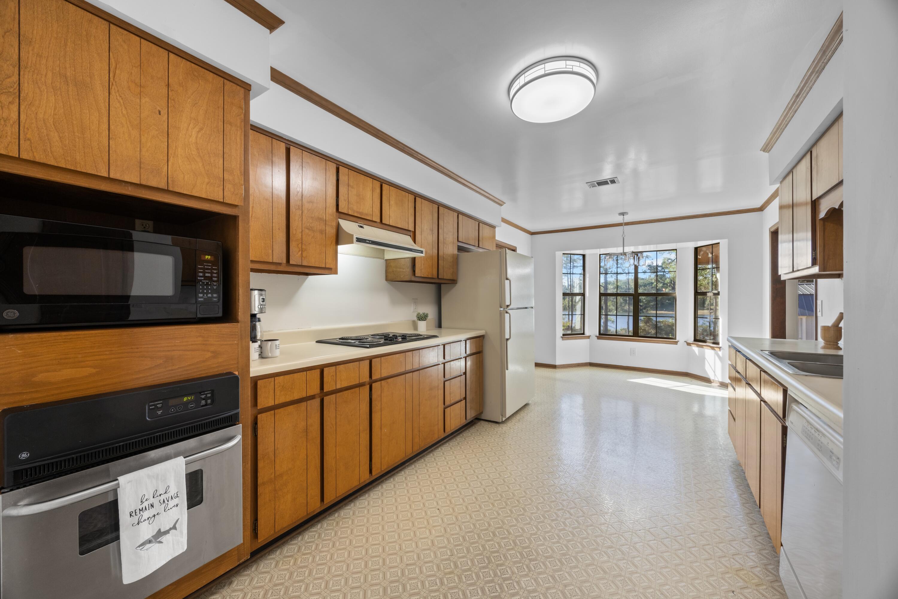3066 Craig Terrace Crestview, FL 32539 - Photo 11 of 43 a large kitchen with stainless steel appliances granite countertop a stove and a sink