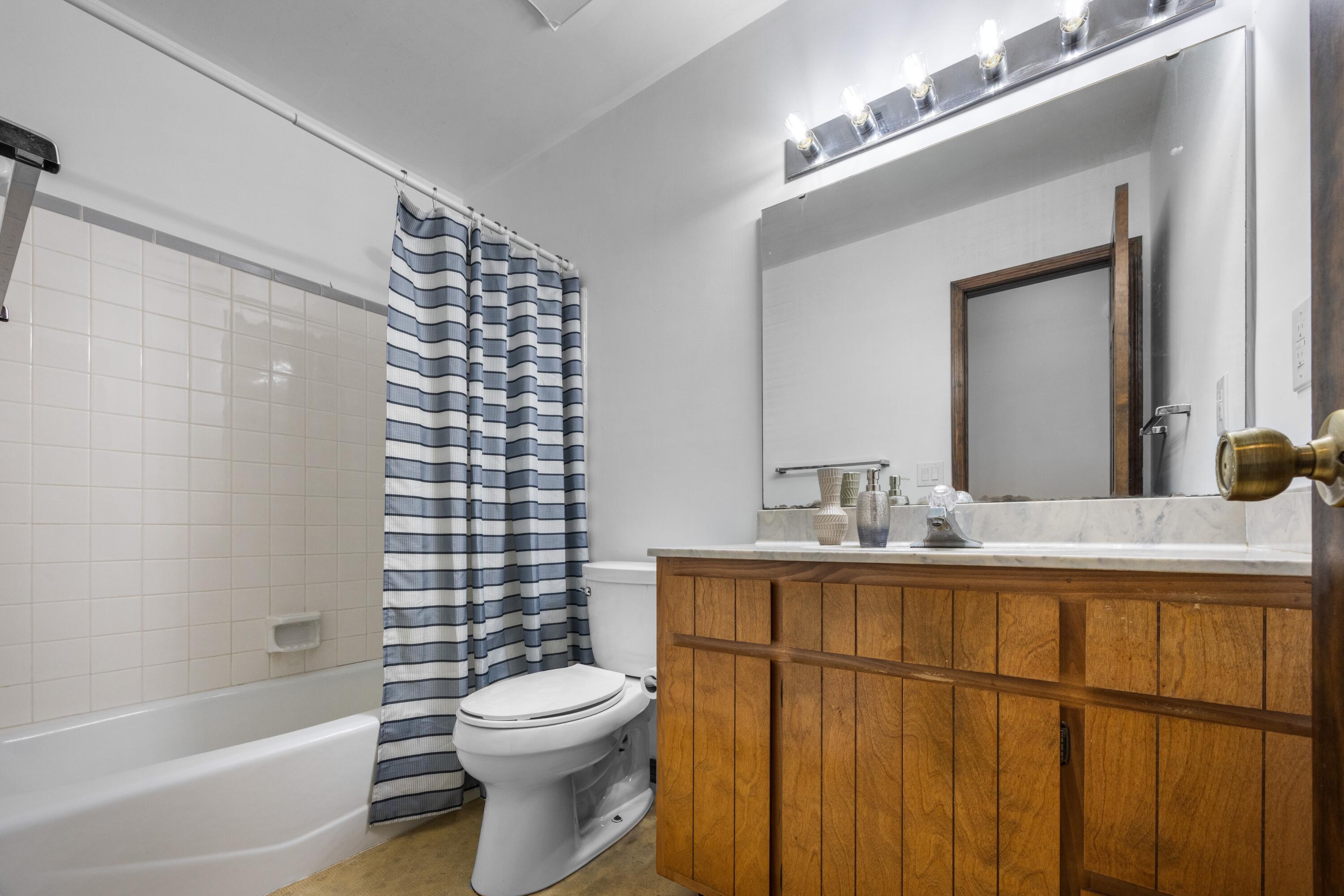 3066 Craig Terrace Crestview, FL 32539 - Photo 20 of 43 a bathroom with a sink a toilet a mirror and shower