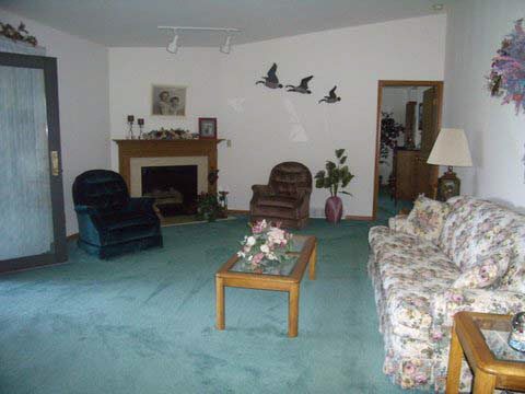 7239 Garden Prairie Road Garden Prairie, IL 61038 - Photo 4 of 11 a living room with furniture and a fireplace
