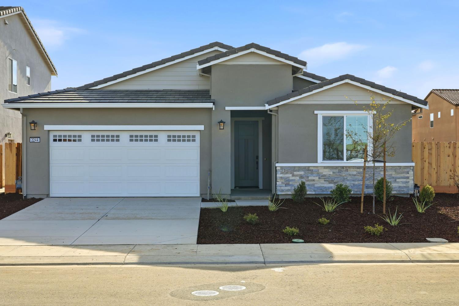 2244 Controllata Street Manteca, CA 95337 - Photo 1 of 11 a front view of a house with yard
