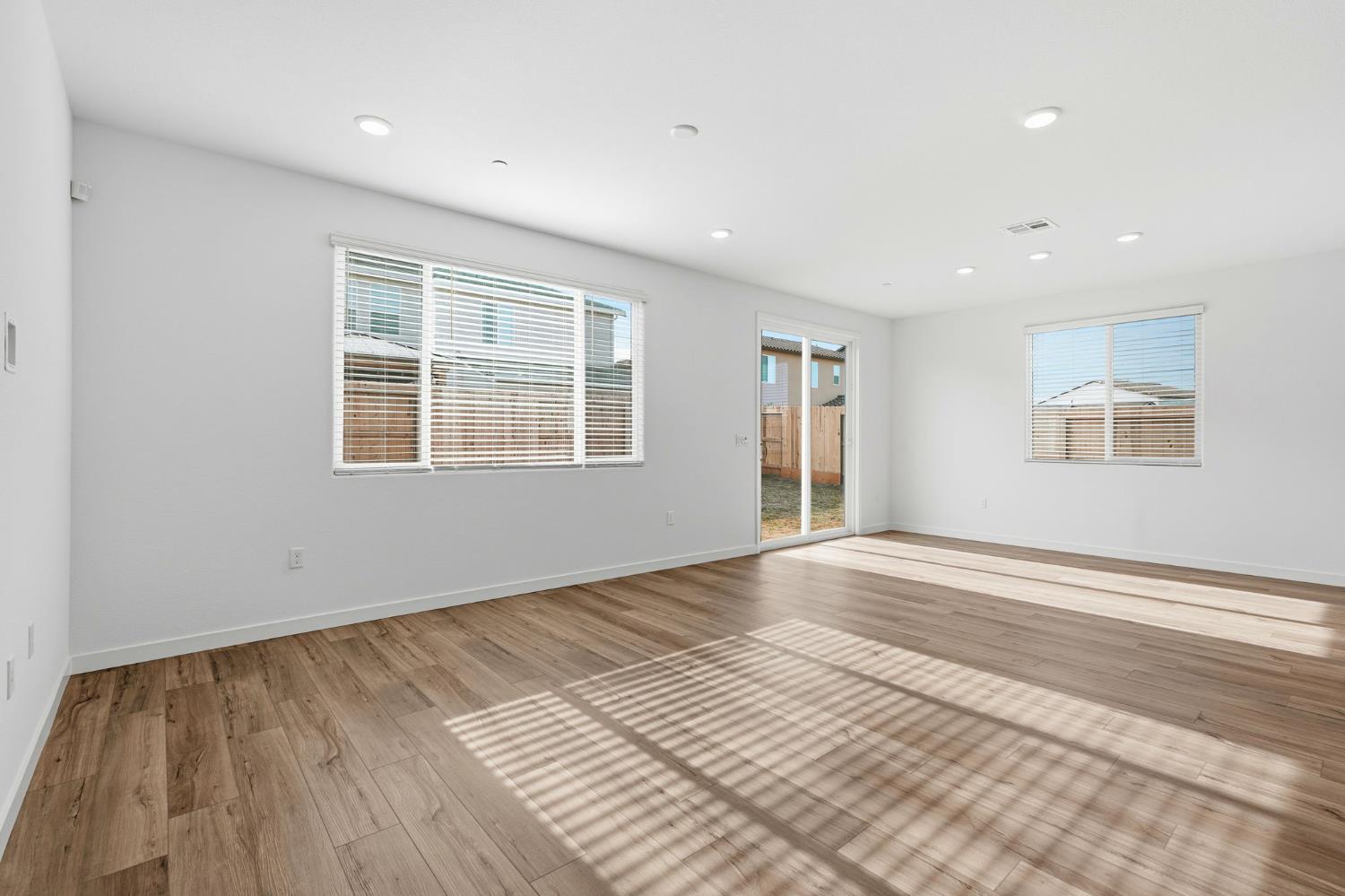 2244 Controllata Street Manteca, CA 95337 - Photo 3 of 11 a view of an empty room with wooden floor and a window