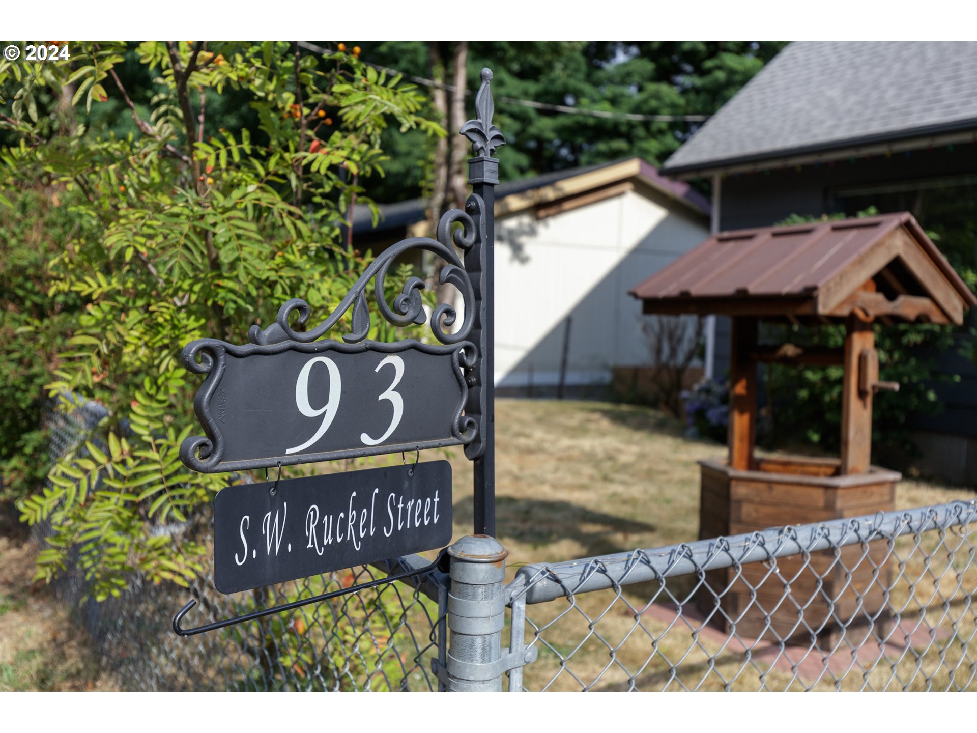 93 Southwest Ruckel Street Cascade Locks, OR 97014 - Photo 11 of 24 a view of outdoor space with a garden and signage